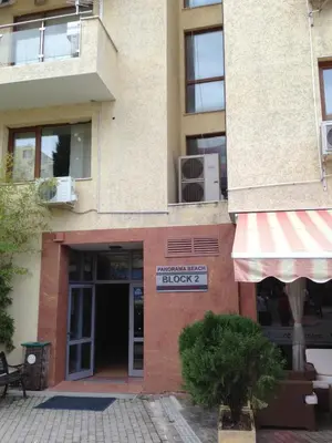 a brick building with a sign that reads lucky at Black Sea Apartment in Nesebar