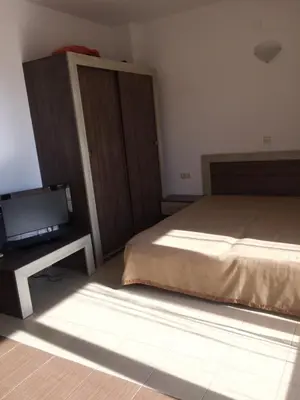 a bedroom with a bed and a tv on a table at Apartment on the sea at St Nikolas Complex-Ira in Chernomorets