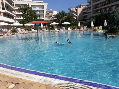 a group of people swimming in a large swimming pool at studio Grand Kamelia in Sunny Beach