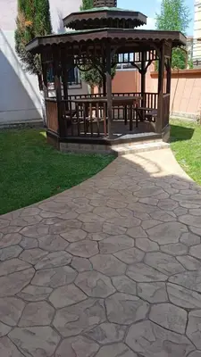 a stone patio with a gazebo in a yard at Dunav Apt.1 in Ravda