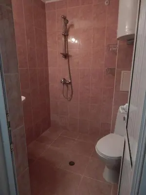 a bathroom with a shower with a toilet at Dunav Apt.1 in Ravda