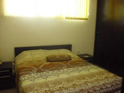 a bedroom with a bed with a blanket on it at Apartament Villa Del Mare in Primorsko