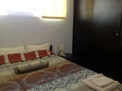 a bedroom with a bed with a blanket on it at Apartament Villa Del Mare in Primorsko