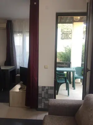 a living room with a couch and a table at Apartment on the sea at St Nikolas Complex-Irina in Chernomorets