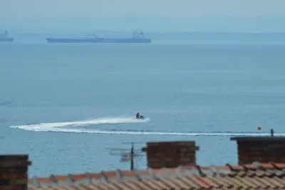 a person on a jet ski in the water at Stamatovi Family Hotel in Pomorie