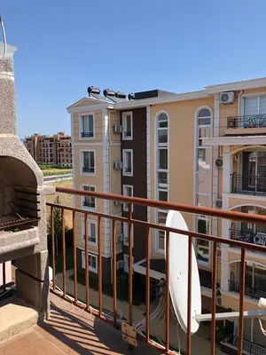 a balcony of a building with a surfboard on it at Dunav Apt.2 in Ravda