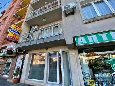 a building with an animal store on a street at Fener Guest House in Pomorie