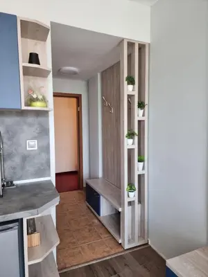a kitchen with wooden shelves and a sink at Complex Astra in Sunny Beach