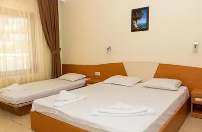two beds in a hotel room with towels on them at Hostel Malibu in Sunny Beach