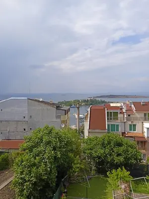 a city with buildings and the ocean in the background at Къща за гости Ганчеви in Sozopol