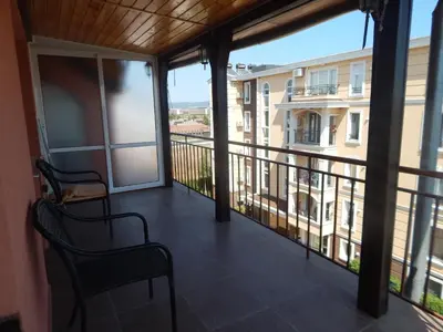 a balcony with a view of a building at Dunav Apt.3 in Ravda