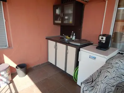 a small kitchen with a sink and a refrigerator at Dunav Apt.3 in Ravda