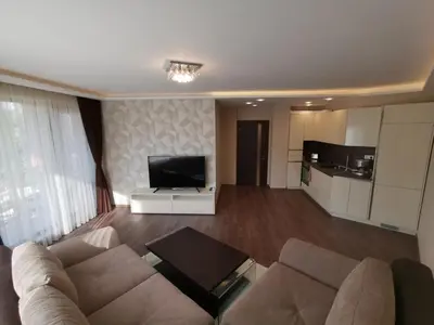 a living room with a couch and a flat screen tv at City Center Lux Apartment in Varna City