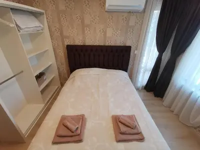 a bedroom with a bed with two towels on it at City Center Lux Apartment in Varna City