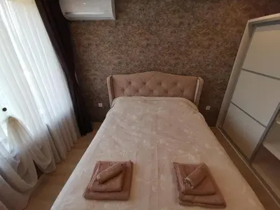 a bedroom with a bed with two towels on it at City Center Lux Apartment in Varna City