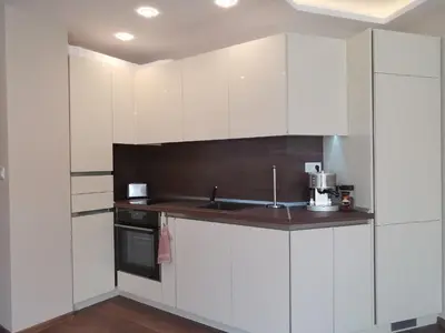 a kitchen with white cabinets and a sink at City Center Lux Apartment in Varna City