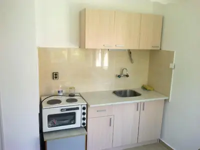 a small kitchen with a sink and a stove at Burgas Urban Studio -Budjet Studio in Burgas City