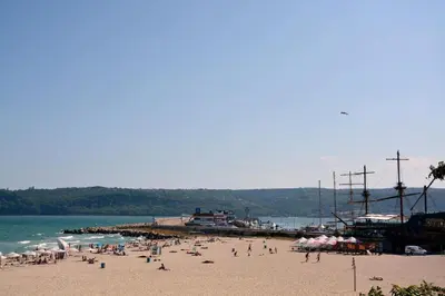a group of people on a beach near the water at Unbeatable Location - New Lux Apartment Varna beach by Flat Mаnager in Varna City