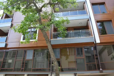 an apartment building with a tree in front of it at Unbeatable Location - New Lux Apartment Varna beach by Flat Mаnager in Varna City