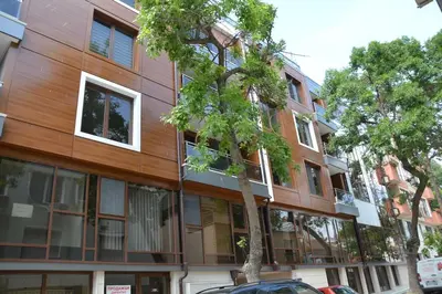 a building with a tree in front of it at Unbeatable Location - New Lux Apartment Varna beach by Flat Mаnager in Varna City