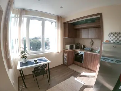 a small kitchen with a table and a refrigerator at By the CATHEDRAL · TOP center · 2 Bedroom FLAT in Varna City