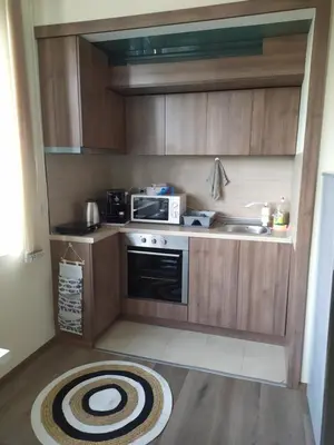 a small kitchen with a stove and a microwave at By the CATHEDRAL · TOP center · 2 Bedroom FLAT in Varna City