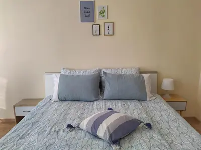 a bed with two pillows on it in a bedroom at By the CATHEDRAL · TOP center · 2 Bedroom FLAT in Varna City