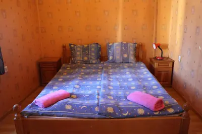 a bed in a room with two pillows on it at Casablanca City in Varna City