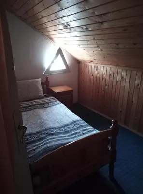 a bedroom with a bed in a wooden cabin at Casablanca City in Varna City