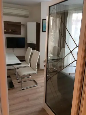 a room with chairs and a table and a glass door at Апартамент Мони in Burgas City