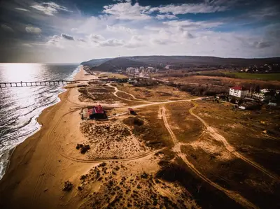 an aerial view of a sandy beach next to the water at Alexander in Shkorpilovtsi