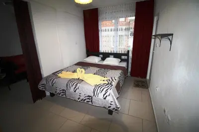 a bedroom with a bed with a yellow bow on it at Zoya Guest House in Ravda