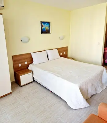 a bedroom with a large white bed in a room at Pool View Studio, Pollo Resort, Sunny Beach in Sunny Beach