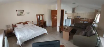a living room with a bed and a couch at Citadel Guest House in Varna City