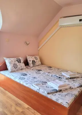 a bed with two books on it in a room at Guesthouse Iceberg in Ravda