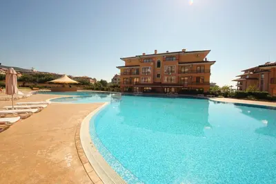 a large swimming pool in front of a building at Menada Sky Dreams Apartments in Sveti Vlas