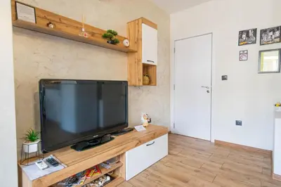 a living room with a large flat screen tv at Joy Apartment Burgas center free parking in Burgas City