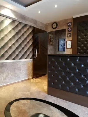 a lobby with a glass table and a clock at Cabana Beach Club Complex in Nesebar
