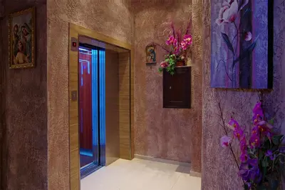 a hallway with a red door and flowers at Cabana Beach Club Complex in Nesebar
