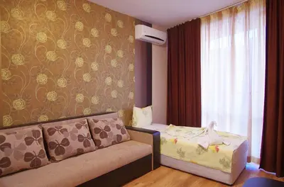 a hotel room with a couch and a bed at Cabana Beach Club Complex in Nesebar
