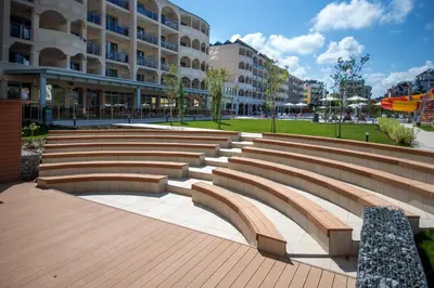 a large amphitheater with benches and a building at Belvedere Hotel - All inclusive in Primorsko