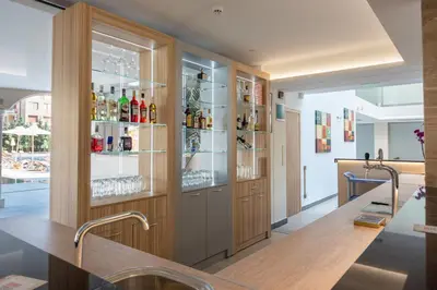 a room with a bar with alcohol bottles at Belvedere Hotel - All inclusive in Primorsko