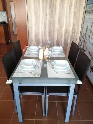 a table with chairs and plates and glasses on it at INFINITY Blue 2 in Burgas City