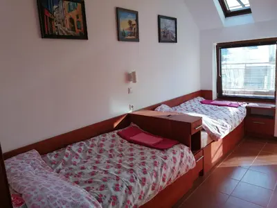 a bedroom with two beds and a desk and a window at INFINITY Blue 2 in Burgas City