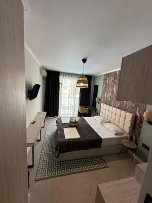 a living room with a bed and a couch at Salena Beach Hotel in Primorsko