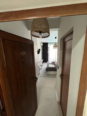 a hallway with a door leading to a living room at Salena Beach Hotel in Primorsko