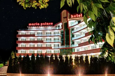 a hotel building at night with a fountain in front at Maria Palace Hotel - All Inclusive in Sunny Beach