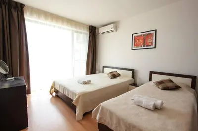 a hotel room with two beds and a window at Seaside Garden Apartment with 2 BR for up to 5 pax in Sunny Beach
