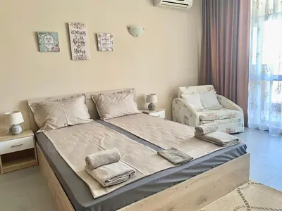 a bedroom with a bed with two towels on it at Apartments in complex ATIA RESORT in Chernomorets