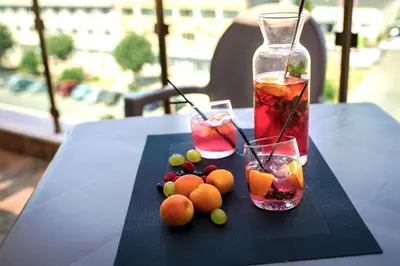 a table with two drinks and some fruit on it at Central Plaza in Pomorie